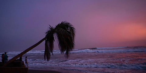 People walk on the beach in Lazaro Cardenas, Mexico. (Photo| AP)