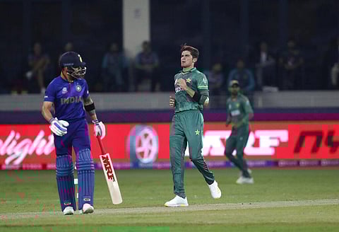 Pakistan's Shaheen Afridi reacts after bowling a delivery to Indian captain Virat Kohli during the ICC World T20 match in Dubai. (Photo | AP)