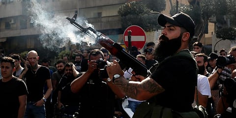 A supporter of the Shiite Amal group fires in the air during the funeral processions of Hassan Jamil Nehmeh, who was killed during Thursday clashes, in the Beirut suburb of Dahiyeh. (Photo | AP)