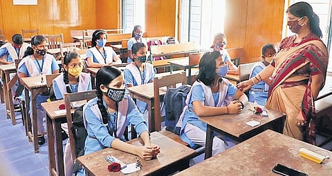 Students of Class VIII attend their first offline class of the current academic session at a school in Bhubaneswar on Monday. (Photo | Irfana)