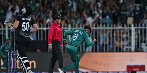 Pakistan's Mohammad Hafeez celebrates the dismissal of New Zealand's Jimmy Neesham during a T20 World Cup match in Sharjah. (Photo| PTI)