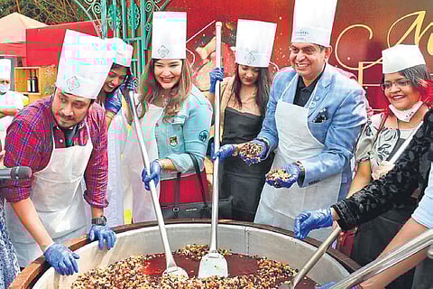 Guests participate in a cake mixing session at Novotel Hyderabad