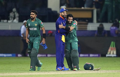 India captain Virat Kohli, centre, congratulates Pakistan's Mohammad Rizwan after Pakistan won the ICC World T20 match between India and Pakistan in Dubai. (Photo | AP)