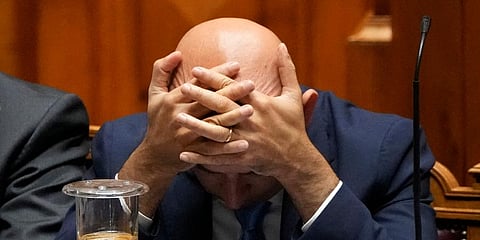 Finance Minister Joao Leao holds his head during a debate at the Portuguese Parliament before the voting of the government's state budget, in Lisbon. (Photo | AP)