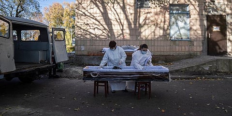 Medical staff prepare a coffin for a body of a patient who died of coronavirus at the morgue of the city hospital 1 in Rivne, 300 kilometers west of Kyiv, Ukraine. (Photo | AP)