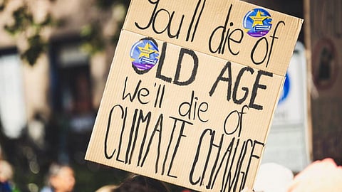 A placard held during a protest against climate change says, "You'll die f=of old age, we'll die of climate change." (Representational Image).