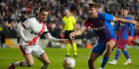 Rayo's Ivan Balliu (L) fights for the ball with Barcelona's Nico Gonzalez. (Photo | AP)