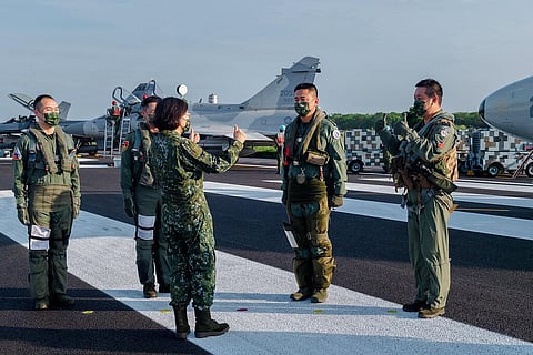 Taiwanese President Tsai Ing-wen, center, speaks with military personnel near aircraft parked on a highway in Jiadong, Taiwan. (File Photo | AP)