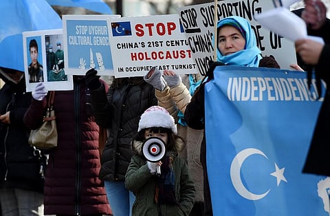 Protesters hold a demonstration against the human rights violation of Muslims in China's  Xinjiang. (Photo| AFP)