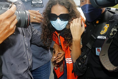 Heather Mack of Chicago, Ill., center, escorted by Indonesian immigration officers to Immigration detention center in Jimbaran, Bali, Indonesia on Friday, Oct. 29, 2021. (Photo | AP)