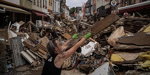A woman throws away rubbish in the center of Bad Neuenahr-Ahrweiler, Germany, Monday July 19, 2021. (Photo | AP)