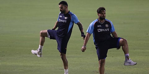 Indian cricket captain Virat Kohli (L) warms up with Rishabh Pant during a training session. (Photo | AP)
