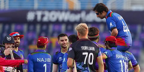 Retiring player Asghar Afghan is carried from the field by his Afghanistan teammates after defeating Namibia. (Photo | AP)