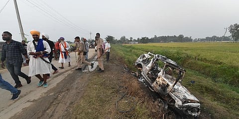 People take a look at the overturned SUV which destroyed in yesterday's violence during farmers' protest, at Tikonia area of Lakhimpur Kheri district, Monday, Oct. 4, 2021. (Photo | PTI)