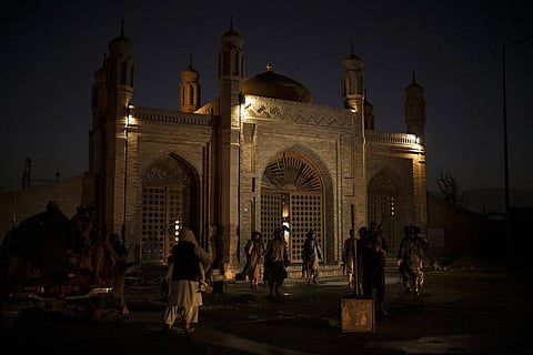 Taliban fighters walk at the entrance of the Eidgah Mosque after an explosion in Kabul, Afghanistan, Sunday, Oct. 3, 2021. (Photo | AP)