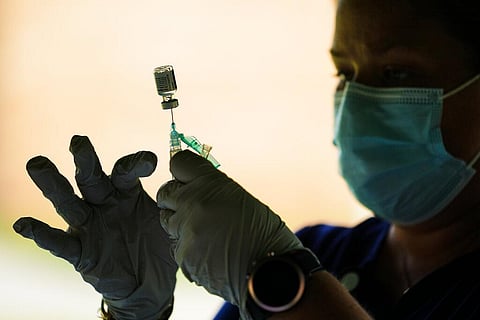 A syringe is prepared with the COVID-19 vaccine at a clinic. (Photo | AP)