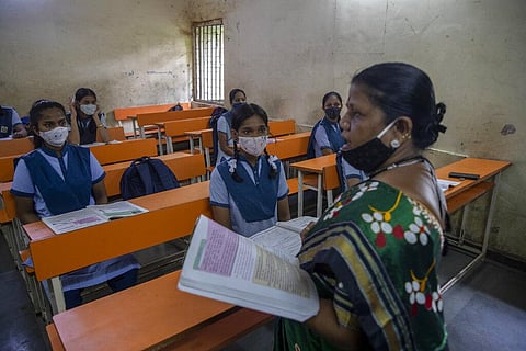 Students attend a class on the partial reopening of a school that remained closed due to the coronavirus pandemic at Dharavi, one of Asia's largest slums, in Mumbai. (Photo | AP)