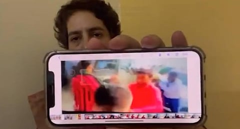 Priyanka Gandhi Vadra holds up her phone to the screen to show the footage of Lakhimpur Kheri violence. (Photo | Twitter screengrab/@priyankagandhi)