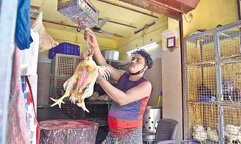 A worker at a chicken outlet in Edappally market | Albin Mathew