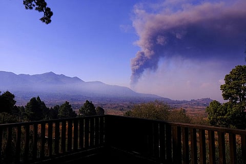 People look as smoke rises on the horizon from a volcano on the Canary island of La Palma, Spain. (Photo | AP)