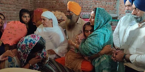 Shiromani Akali Dal Leader Harsimrat Kaur Badal consoles the family of Lovepreet Singh, the 19-year-old farmer killed in Lakhimpur Kheri. (Photo | Twitter, Harsimrat Badal)