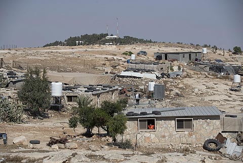 FILE - The Israeli settlement of Ma'on, in the background and overlooks the the West Bank Palestinian Bedouin village of al-Mufagara, near Hebron, Sept. 30, 2021. (File photo | AP)