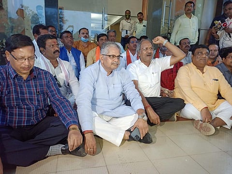 Opposition BJP leaders sitting on dharna outside the circuit house in Kawardha district after they were denied permission by the administration. (File Photo | Special arrangement)