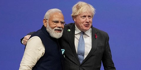 British PM Boris Johnson (R) greets PM Narendra Modi, at the COP26 U.N. Climate Summit in Glasgow, Scotland. (Photo | AP)