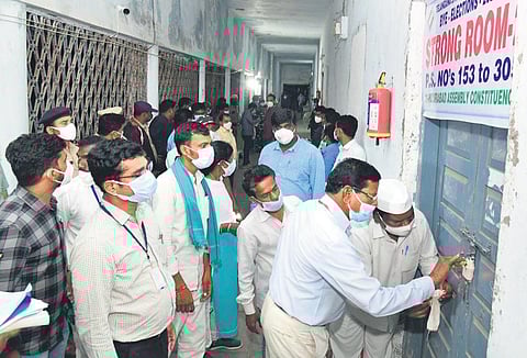 Election authorities seal the strongrooms, where the EVMs have been kept, at the SRR Government Degree College in Karimnagar on Sunday