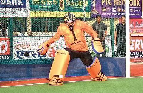 Chief Minister Charanjit Singh Channi goes for a save during an exhibition display in between the Surjit Hockey Tournament final | express