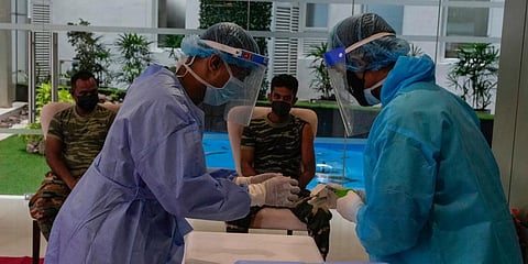 Sri Lankan army soldiers wait to receive the third jab of anti coronavirus vaccine in Colombo. (Photo | AP)