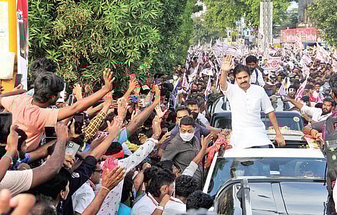 Jana Sena chief Pawan Kalyan waving to his fans and supporters on way to the public meeting at Kurmannapalem in Visakhapatnam on Sunday I G Satyanarayana