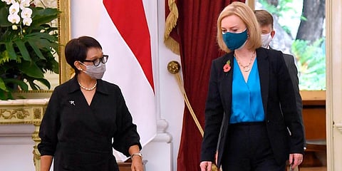 Britain's Foreign Minister Elizabeth Truss (R) walks with her Indonesian counterpart Retno Marsudi prior to their meeting with President Joko Widodo, at Merdeka Palace in Jakarta. (Photo | AP)