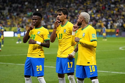 Brazil's Lucas Paqueta, center, celebrates with teammates Vini Jr, left, and Neymar after scoring his side's opening goal against Colombia during a qualifying soccer match for the FIFA World Cup Qatar
