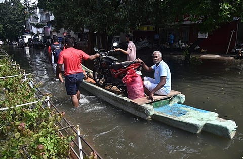In Chennai, local residents still sailing on  boats to cross the localities at Peravallur, Kolattur, following flooding caused by recent rains. (Express I P Jawahar)