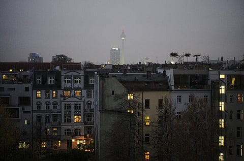 The television tower, one of the landmarks of the German capital, rises into the hazy sky behind residential buildings in Berlin. (Photo | AP)