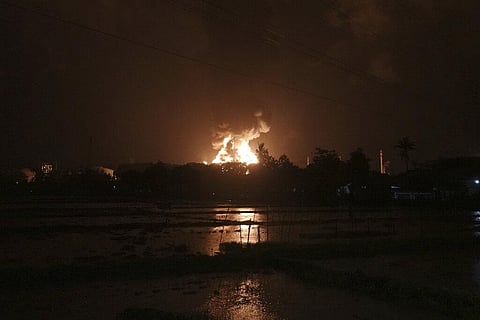 The sky glows from the fire that razes through an oil refinery owned by the national oil company Pertamina, in Cilacap, Central Java, Indonesia. (Photo | AP)