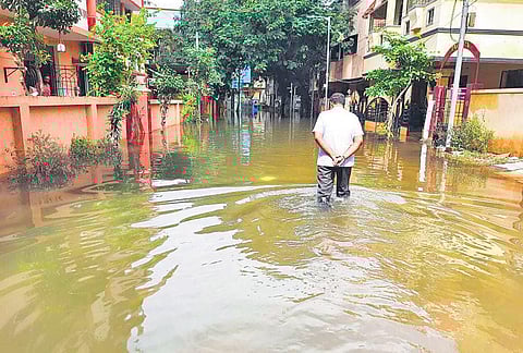 A man wading through waterlogged Narasiman street at West Mambalam in Chennai | Express