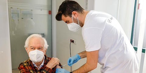 The patient Kurt Switil, left, receives a Pfizer vaccination against the COVID-19 disease by a doctor in the vaccination center, Am Schoepfwerk' in Vienna, Austria. (Photo | AP)