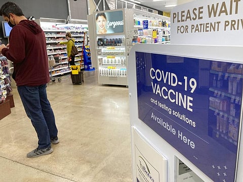 A patient waits to be called for a COVID-19 vaccination booster shot outside a pharmacy in a grocery store. (Photo | AP)
