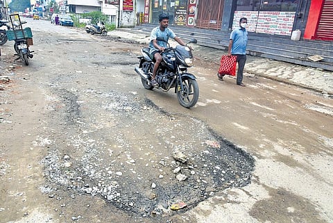 Potholes and craters appeared after heavy rains on the Oil Mill Road at Iyyappanthangal in Chennai | Martin Louis