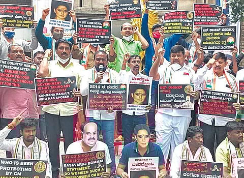 Congress workers prortest against the Bitcoin scam and actress Kangana Ranaut for her statement on the country’s freedom, in Bengaluru on Saturday