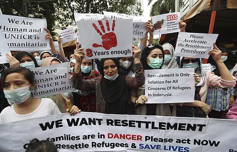 Afghan women and children refugees living in Indonesia hold posters during a rally outside a building that houses UNHCR representative office in Jakarta, Indonesia, Monday, Nov. 15, 2021. (Photo | AP)