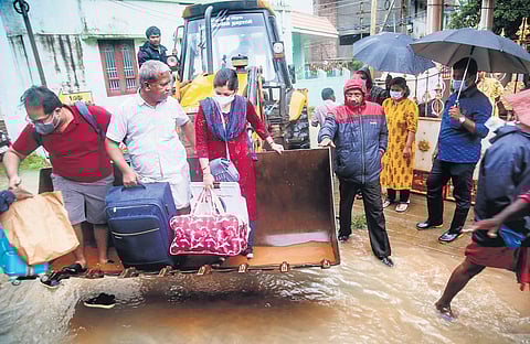 People being shifted on an earthmover in Kanniyakumari on Sunday | PTI