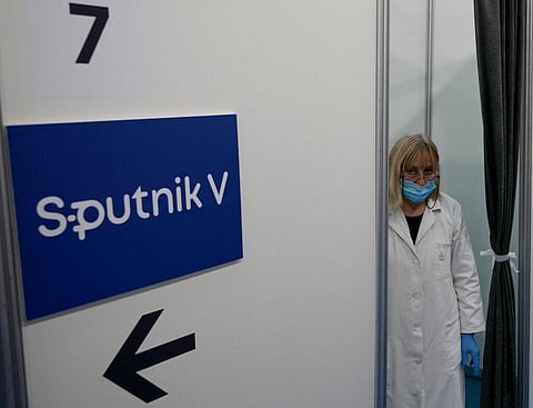 A medical worker wearing protective gear, waits for patients to receive the COVID-19 vaccine at Belgrade Fair makeshift vaccination center, Serbia. (Photo | AP)