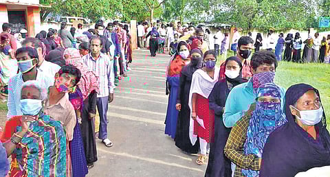 People stand in long queues at a polling station in Kuppam on Monday to exercise their franchise in the municipal election | EXPRESS