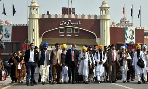 Pakistan Sikh officials with Indian Sikh pilgrims at Wagah Border as they arrive to celebrate 552nd birth anniversary of Guru Nanak Dev, in Pakistan, Wednesday, Nov. 17, 2021. (Photo | PTI)