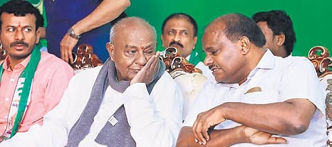 Former PM HD Deve Gowda has a word with his son HD Kumaraswamy at the  JDS’ ‘Janata Sangama’ workshop in Bengaluru on Tuesday | EXPRESS
