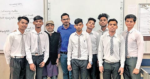 The team of students who created the alarm (inset), which comes with the motto ‘Safe Kitchens Catch no Flame’. It costs `700 per piece.