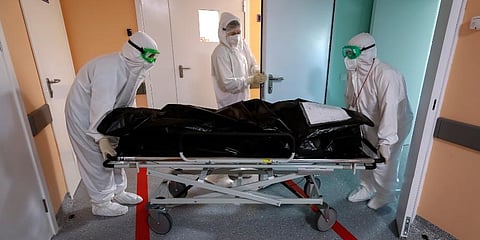 Medics wearing special suits to protect against coronavirus transport the body of a COVID-19 victim at an ICU of a hospital in Kalach-on-Don, 73 km south-east of Rostov-on-Don, Russia. (Photo | AP)